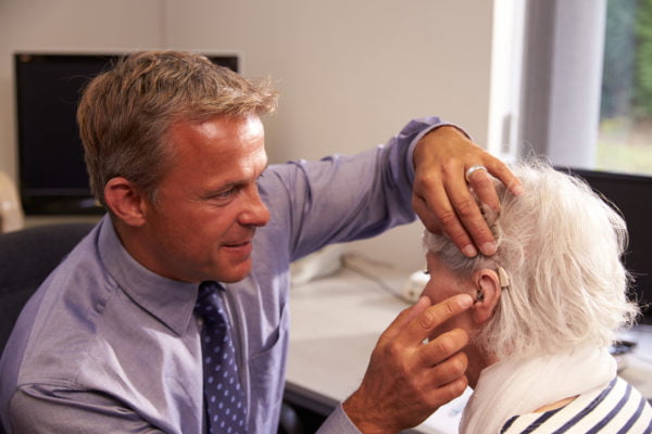 A patient being fitted with a hearing aid