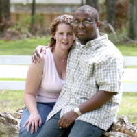 Young couple sitting on a tree trunk
