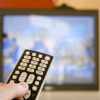 A remote control in someone's hand