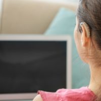 Woman with hearing loss using a laptop
