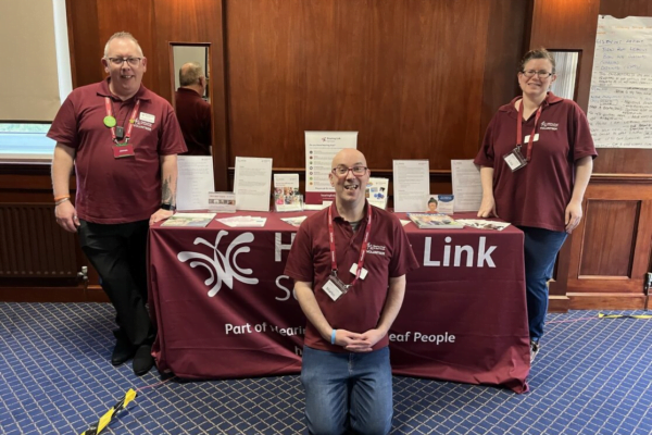Three peer support volunteers providing guidance for hearing loss