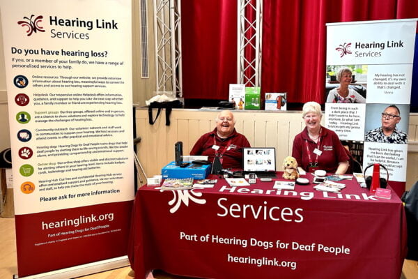 Hearing Link Services volunteers at an external event with our burgundy stand